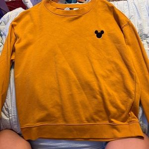 Mustard yellow with a Mickey Mouse shaped head in black